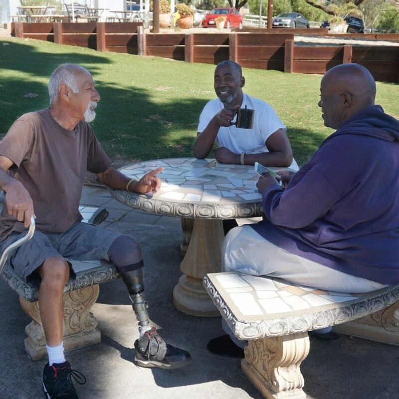 Men sharing conversation outdoors